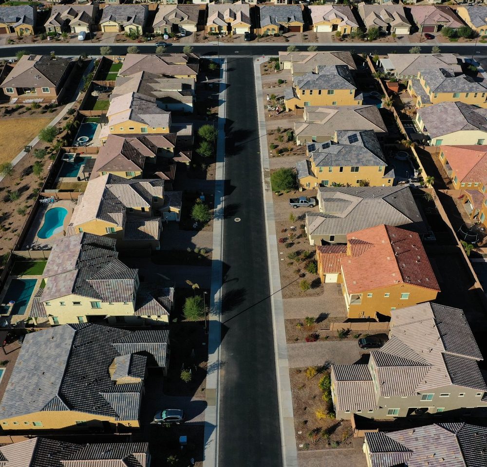 Aerial view of a suburban neighbourhood of single-family homes, the geography fair lending analysis examines